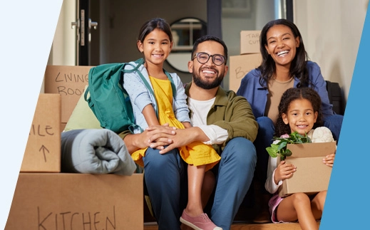 Family on porch with moving boxes